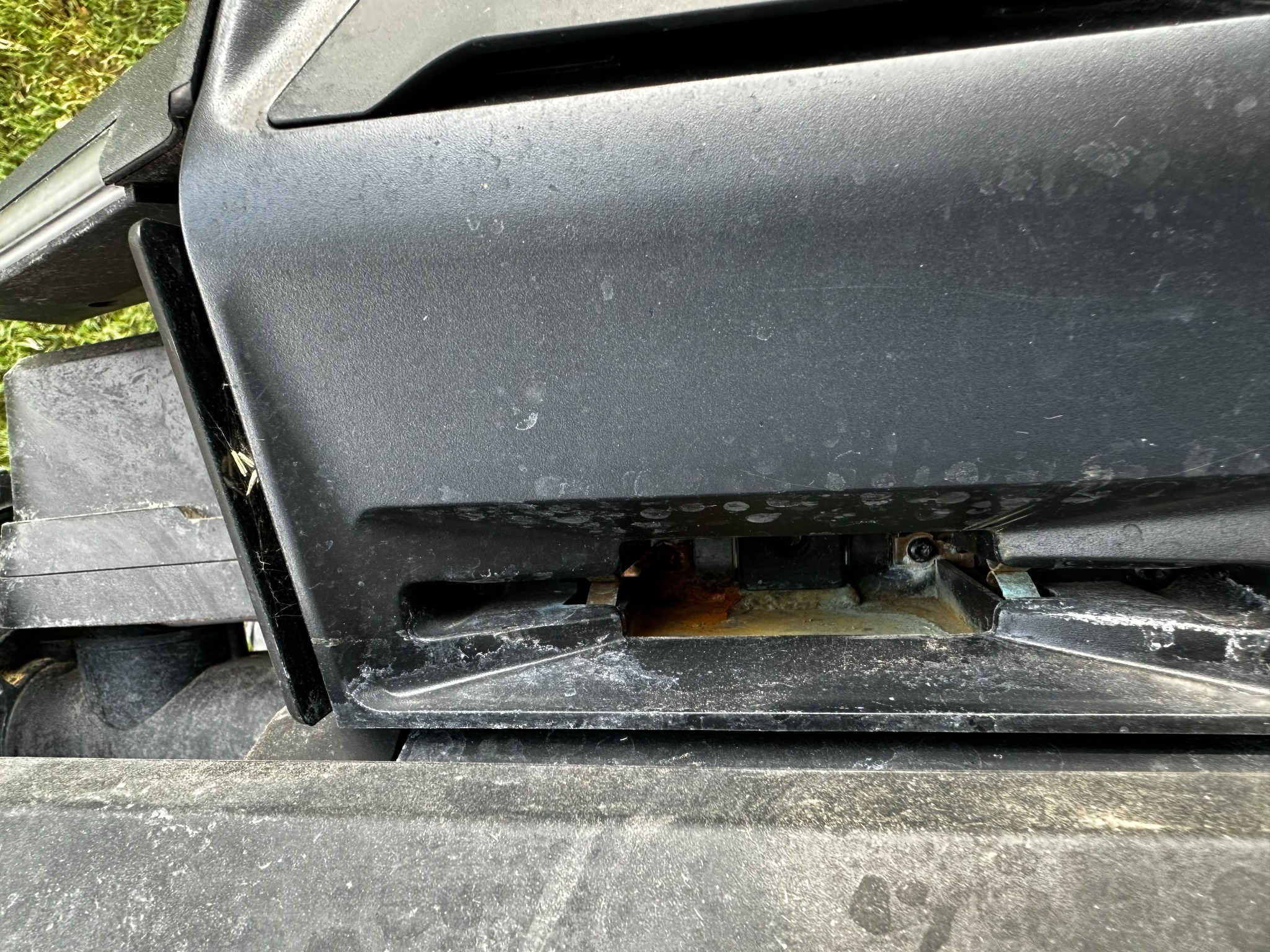 Close-up of the Navimow X430 charging cavity showing standing water and residue buildup