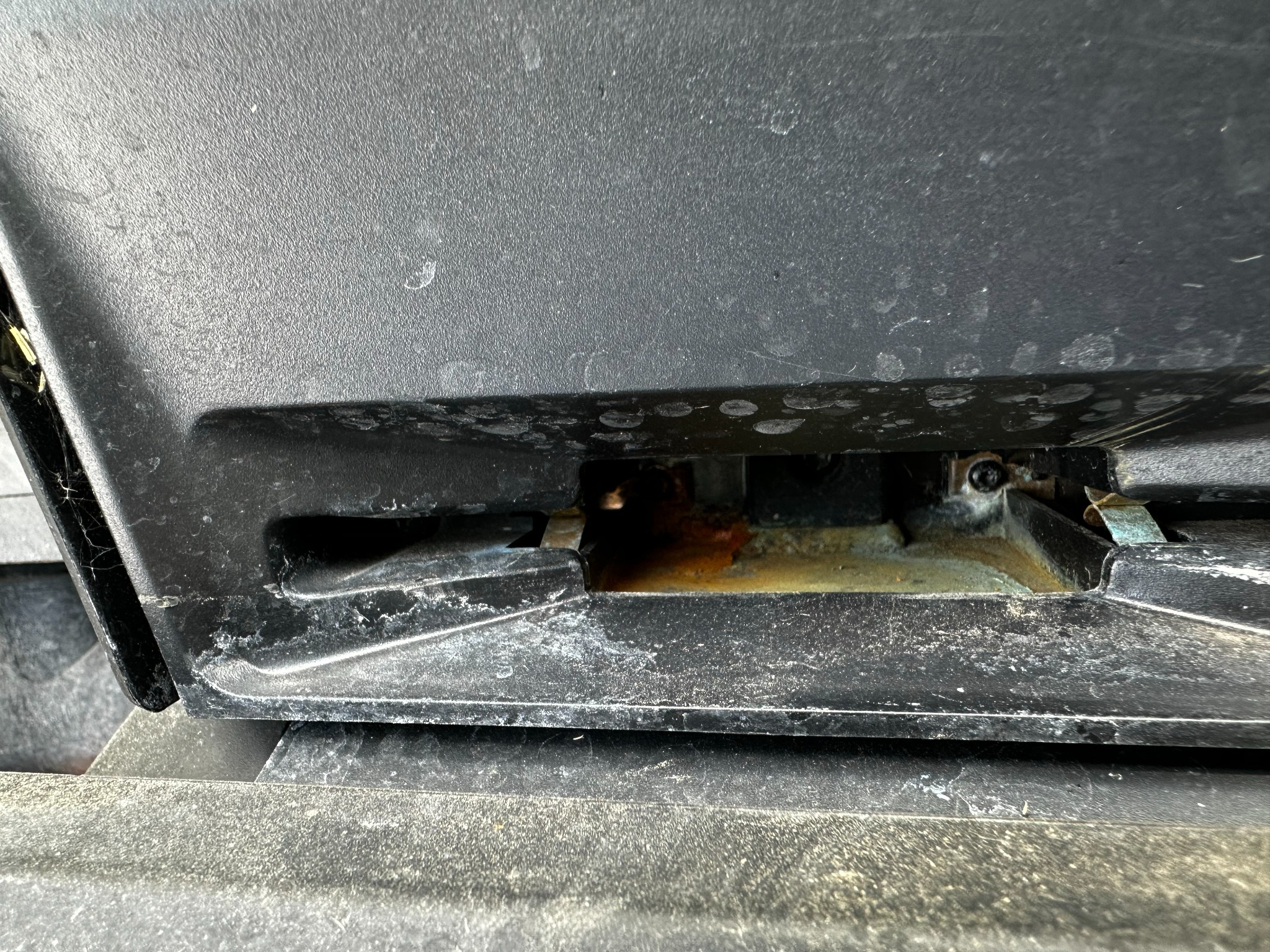 Detailed close-up of the Navimow X430 front charging area with water and buildup visible